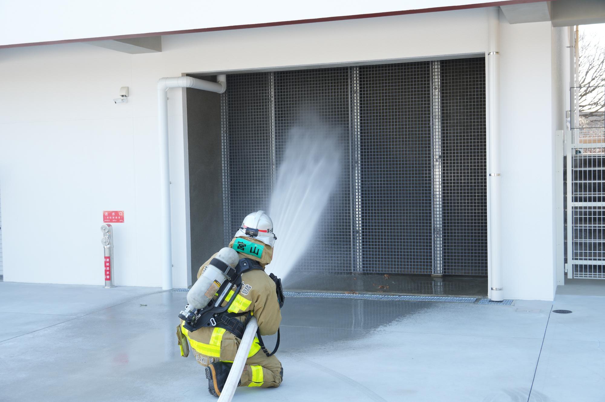 放水壁に消火している消防士